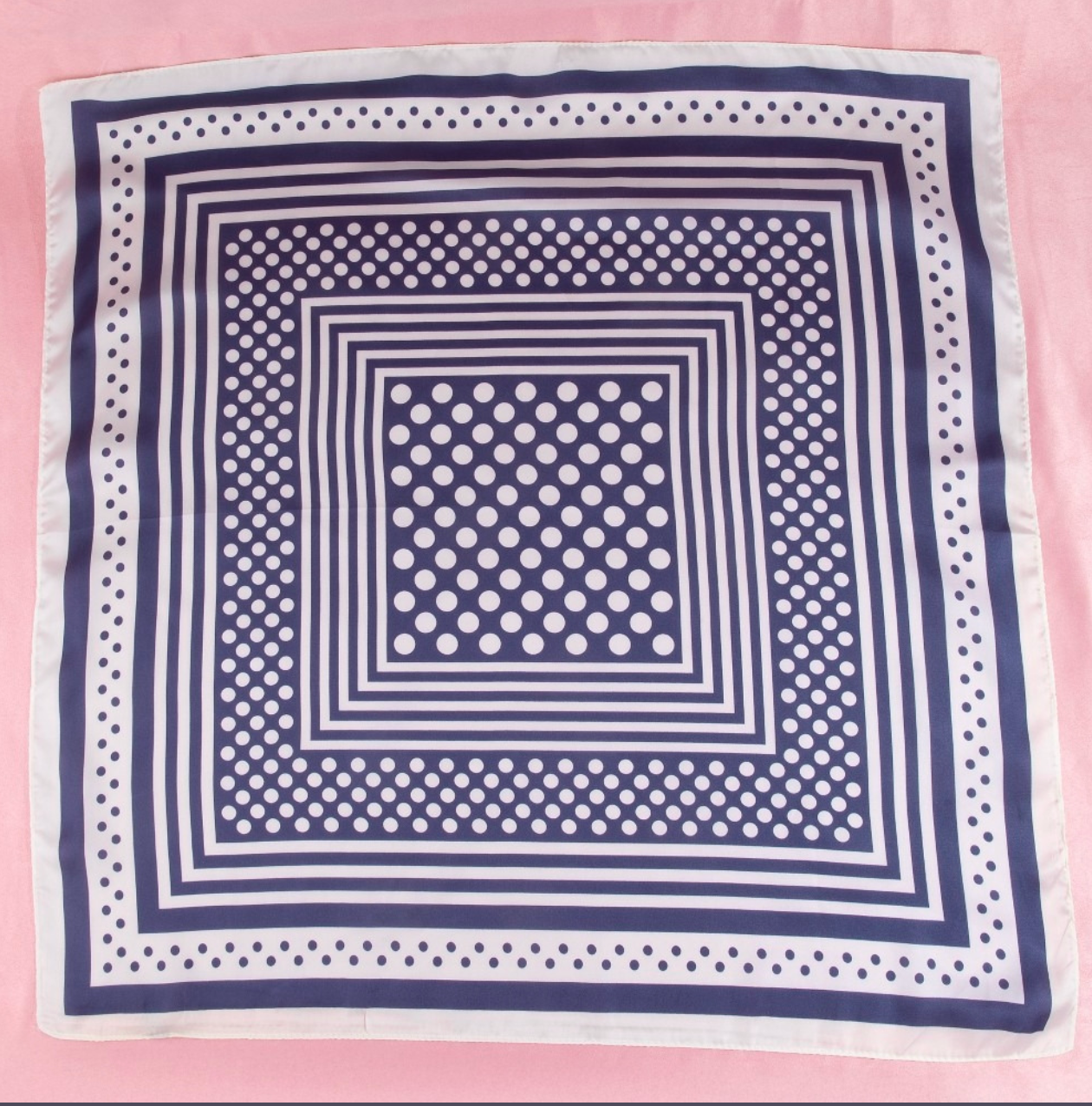 Navy satin square scarf featuring a concentric square design with white polka dot accents and striped borders.