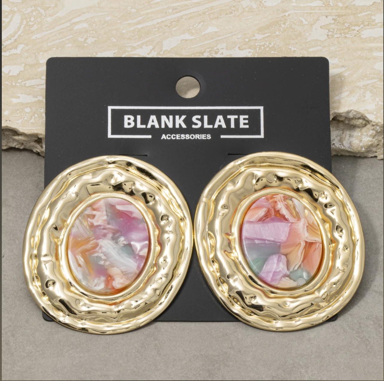 Hammered gold oval stud earrings with pastel marbled terrazzo-style oval centers.