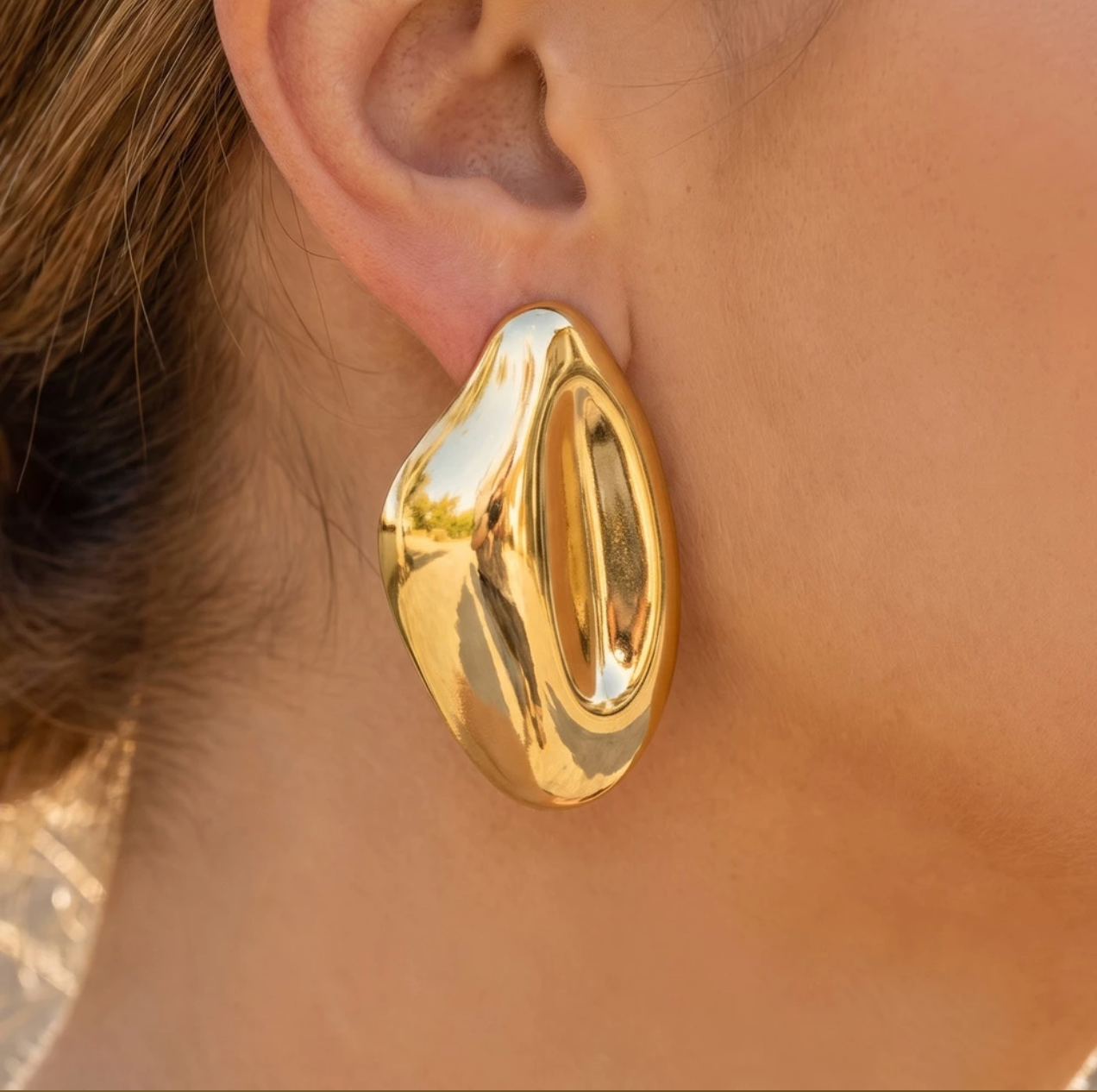 Oversized gold-dipped sculptural puffy stud earrings with a high-shine organic teardrop design.
