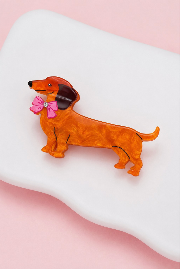 A Little Something pink dachshund dog hair claw clip with bright pink bow and rhinestone accent.