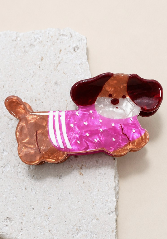 Fido Claw Clip Pink featuring a brown dog design with a bright pink star-print outfit and white striped accents.