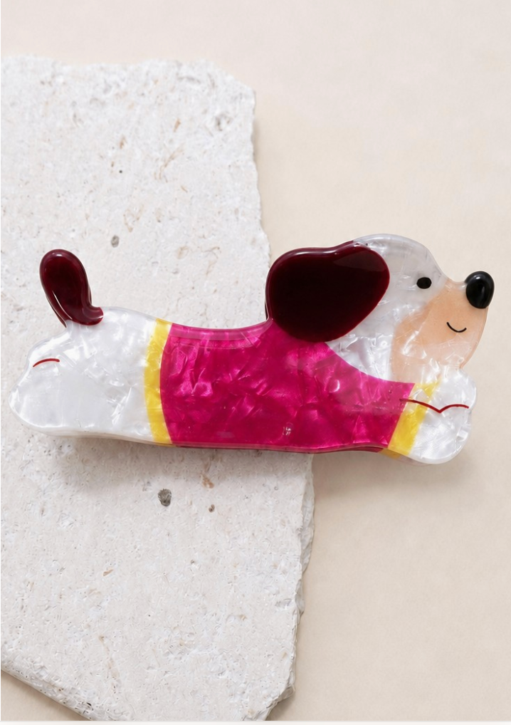 Fido Claw Clip Red dog-shaped acrylic hair clip with pearly white body, deep red details and bright pink outfit.