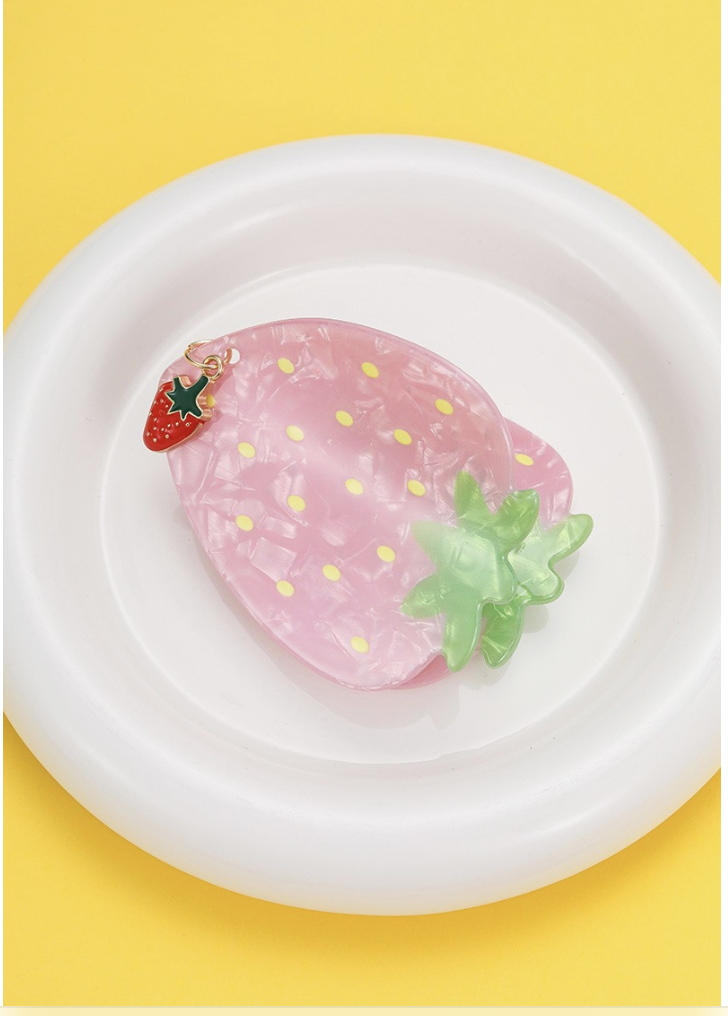 Fruit Salad Strawberry hair claw clip in pearly pink with yellow seed details, green leaves and a dangling strawberry charm.