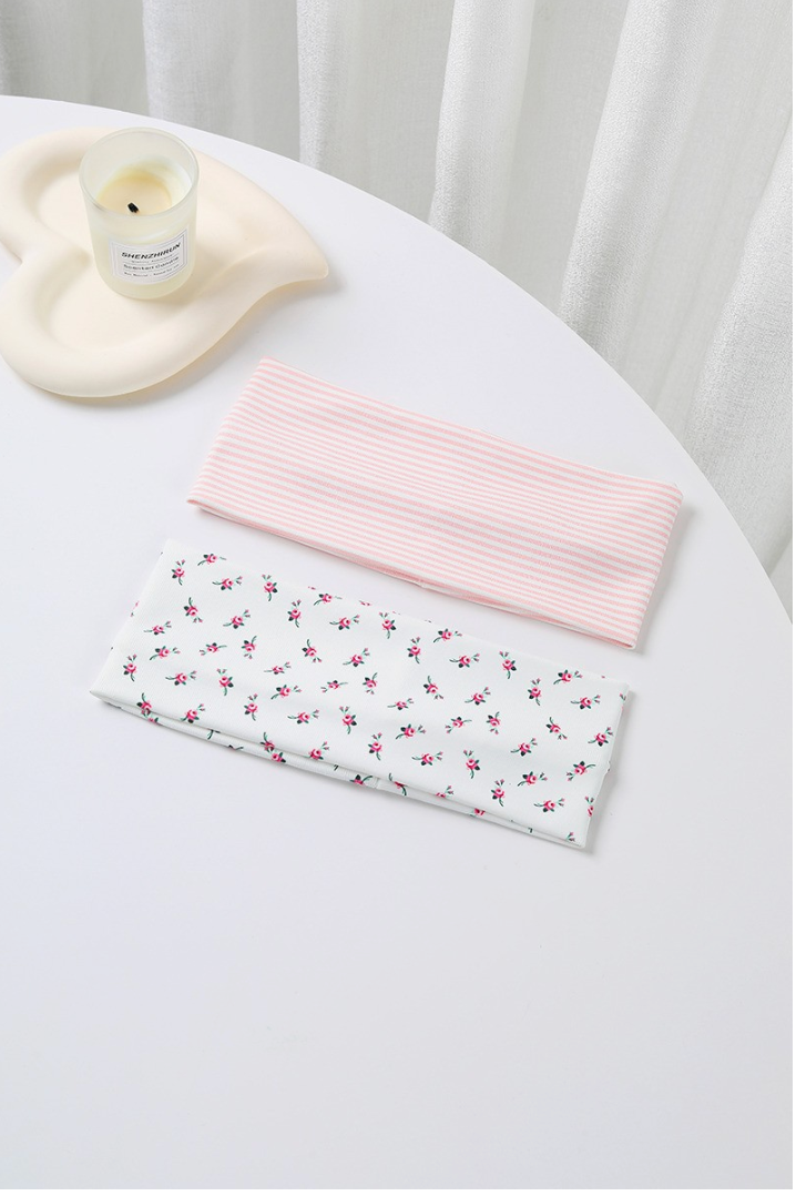 Dreaming Of Pinstripe Headband Set featuring a white rosebud floral headband and pastel pink striped wide headband.