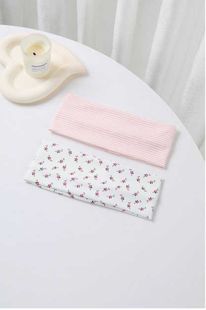 Dreaming Of Pinstripe Headband Set featuring a white rosebud floral headband and pastel pink striped wide headband.