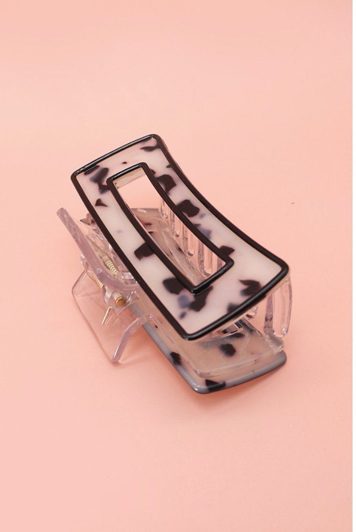 Still Climbing Tortoise Claw Clip Black featuring a rectangular hollow acetate frame, black border and neutral tortoise shell pattern.