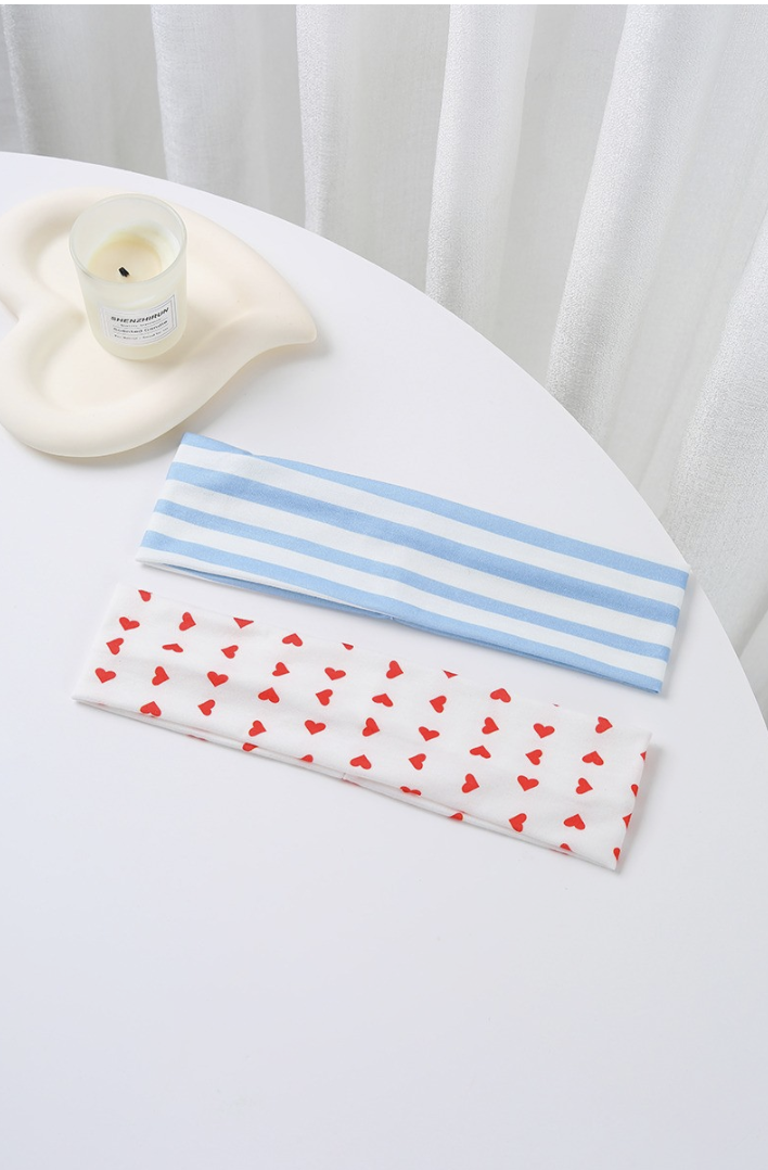 Mixed Feelings Striped Headband Set featuring a dusty blue and white striped headband and white headband with red heart print.