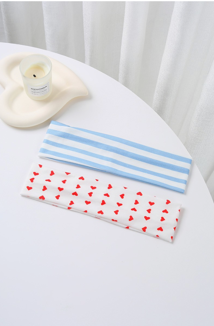 Mixed Feelings Striped Headband Set featuring a dusty blue and white striped headband and white headband with red heart print.