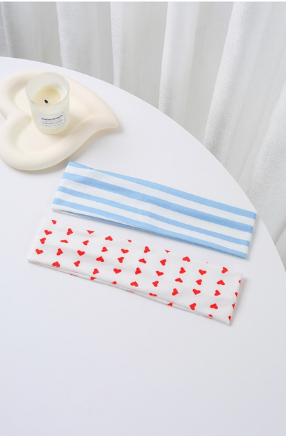 Mixed Feelings Striped Headband Set featuring a dusty blue and white striped headband and white headband with red heart print.