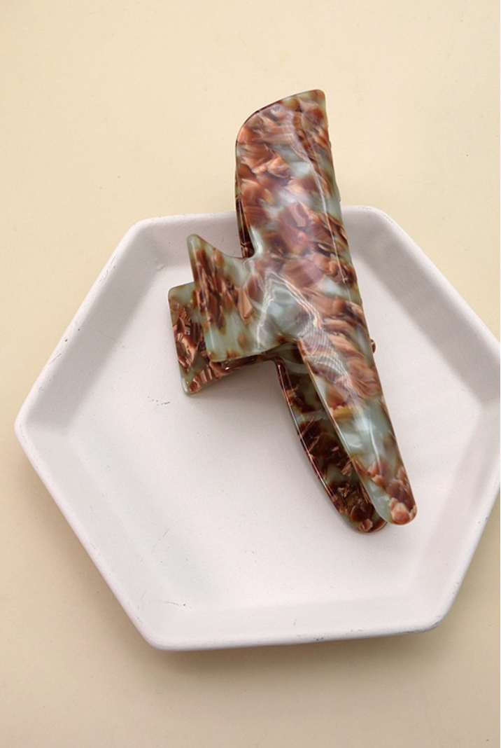 Overtime Oblong Claw Clip Brown featuring an oversized curved cellulose hair clip with brown, sage green, cream and amber marbling.