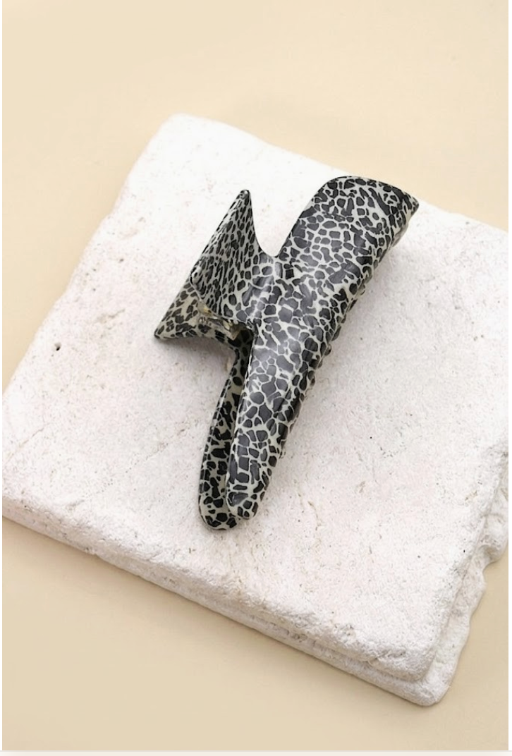 Overtime Oblong Claw Clip Dotted featuring an oversized curved cellulose hair clip with black and gray speckled pattern.