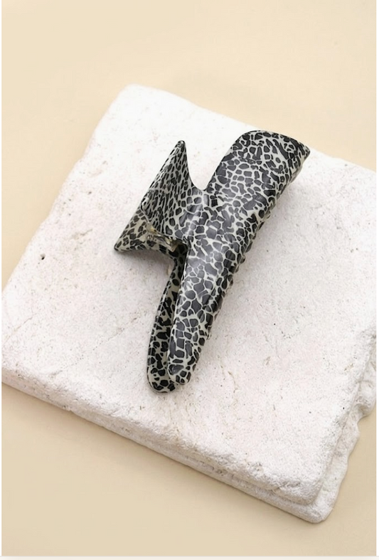 Overtime Oblong Claw Clip Dotted featuring an oversized curved cellulose hair clip with black and gray speckled pattern.