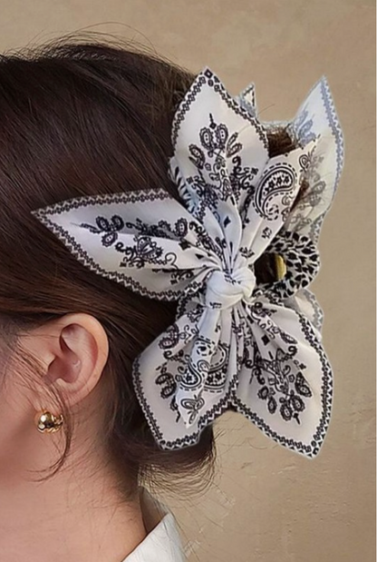 Taylor Paisley Claw Clip Black featuring an oversized black and cream paisley bow hair clip styled in an updo.