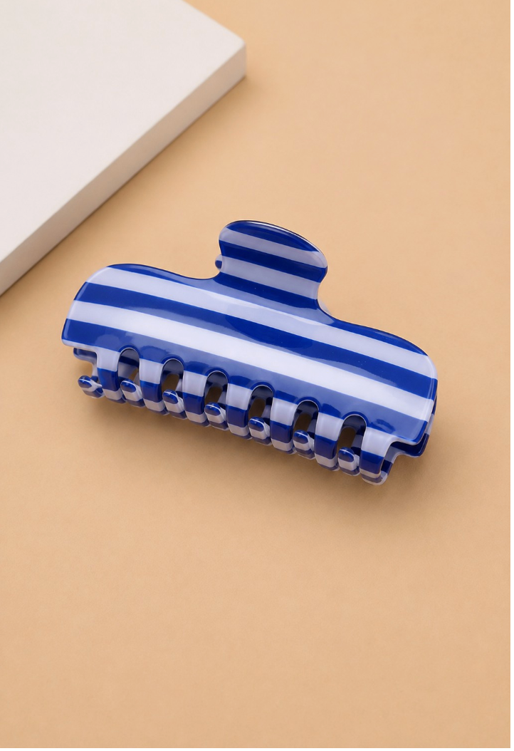 Father Figure Striped Claw Clip Blue featuring a glossy cobalt blue and white striped acetate hair claw with interlocking teeth.