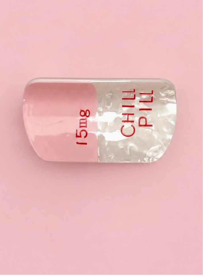 Chill Pill Claw Clip Pink novelty pink and pearlescent white pill-shaped hair clip with red lettering