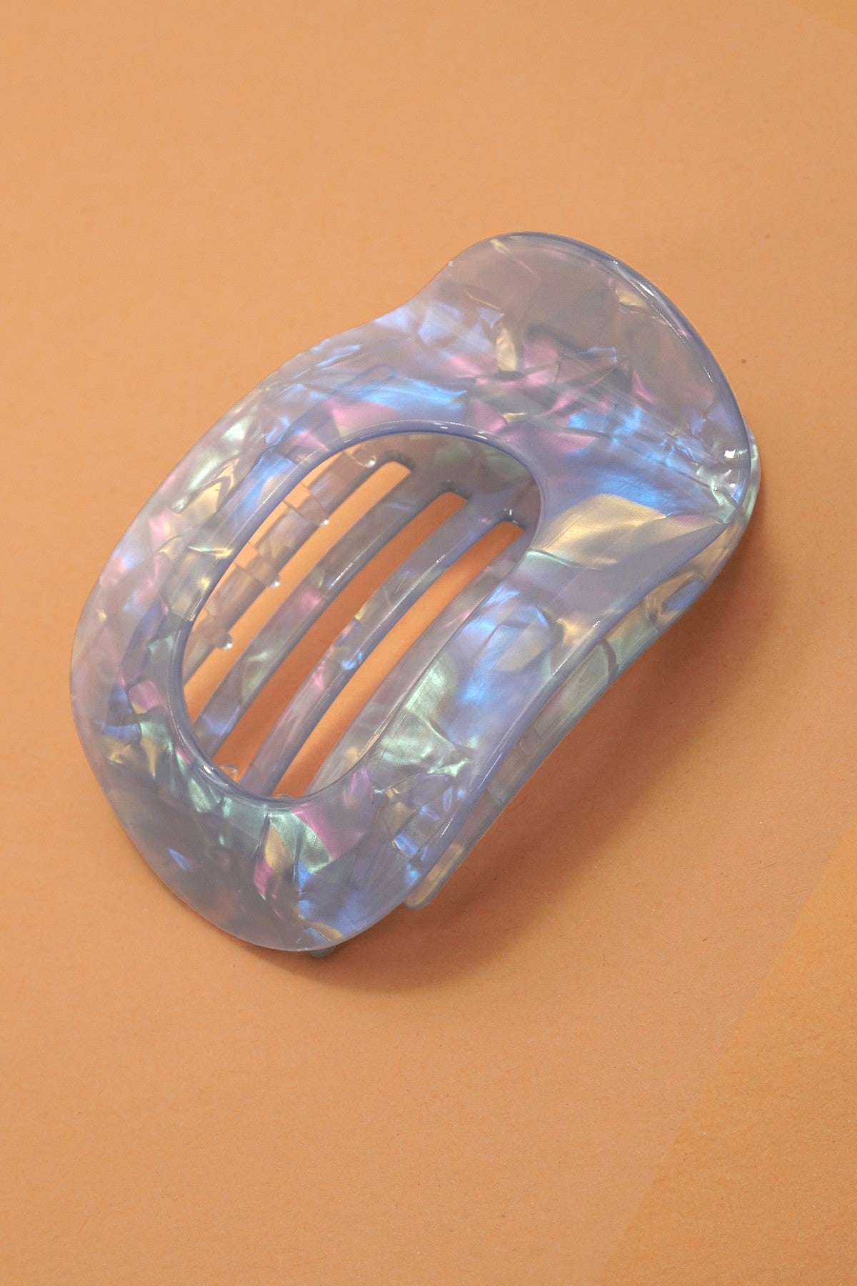 Iridescent hair clip on a brown background
