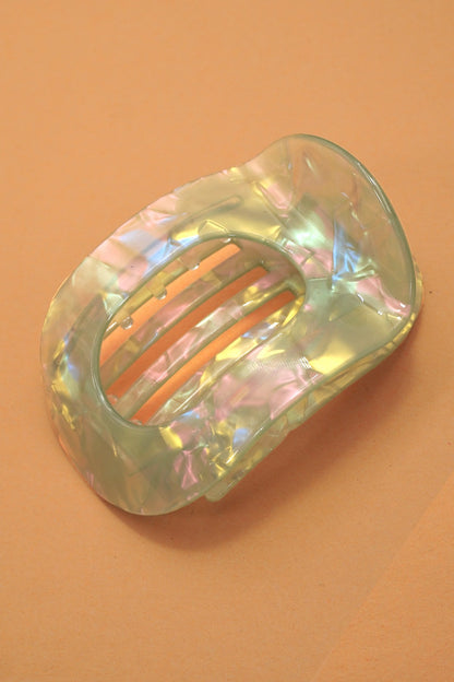 Iridescent hair clip on a peach background