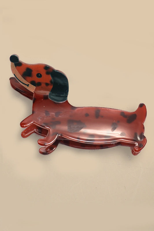 Dog-shaped hair clip on a beige background