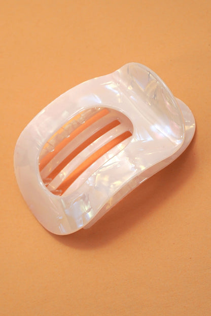 Oval lay flat iridescent hair claw clip designed for comfortable all day hold in multiple colors