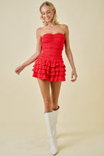 Load image into Gallery viewer, Model wearing red strapless smocked romper dress with tiered ruffle hem and shorts lining