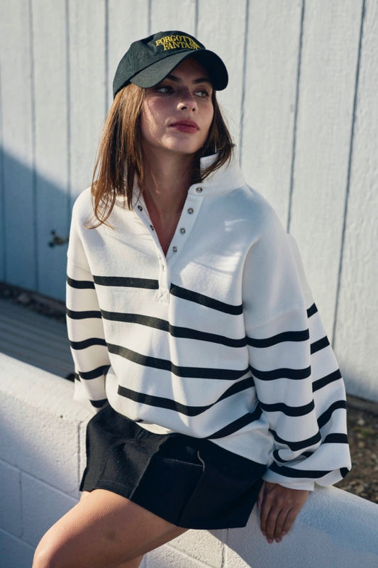 Model wearing Addison Stripe Pullover, oversized striped polo sweatshirt with button placket.