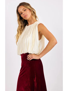 Woman wearing a white sleeveless top and red skirt on a white background