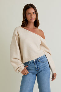 Model wearing Cloudline Asymmetric Sweater with off-shoulder neckline and balloon sleeves