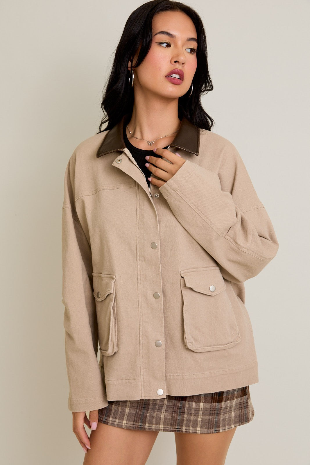 Model wearing Rustic Edge Barn Jacket in beige cotton with contrast leather collar