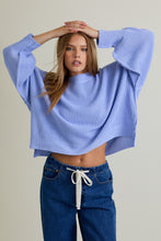 Load image into Gallery viewer, Model wearing periwinkle oversized mock-neck pullover sweater with balloon sleeves and side-slit hem.