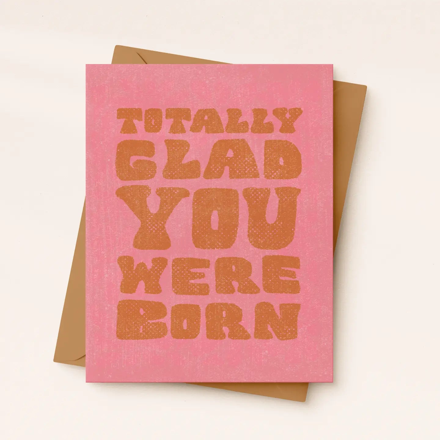 Pink card with brown text 'TOTALLY GLAD YOU WERE BORN' on a white background