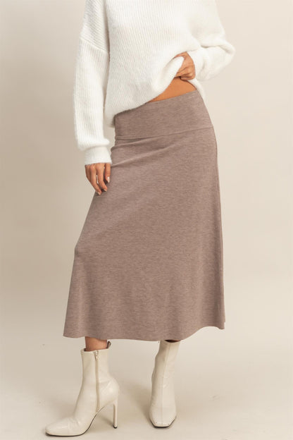 Model wearing Sculpted Ease Knit Skirt in taupe ribbed knit with midi length and clean silhouette