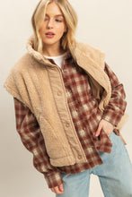 Load image into Gallery viewer, Model wearing beige sherpa vest with snap button placket, tie-up side details, and cap-sleeve effect layered over plaid shirt.