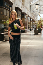 Load image into Gallery viewer, Model wearing black and white polka dot cowl neck top with matching midi skirt