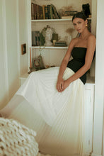 Load image into Gallery viewer, woman wearing black and ivory strapless pleated maxi dress