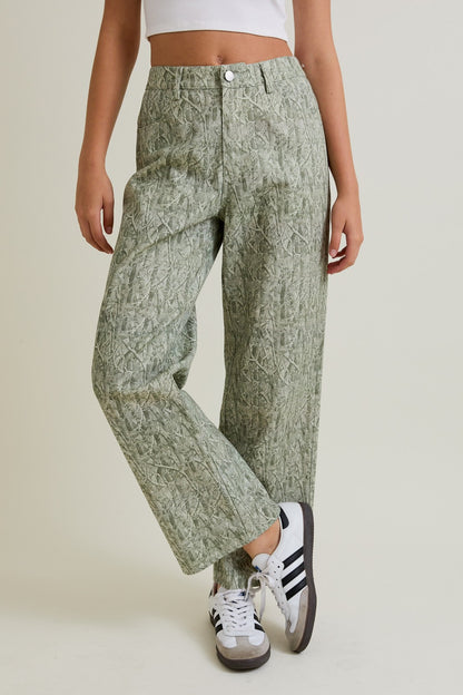 Woman wearing mid-rise tree camo graphic wide-leg cotton pants styled with sneakers