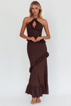Load image into Gallery viewer, Model wearing Cocoa Ruffle Cutout Dress in chocolate brown with halterneck and ruffle details
