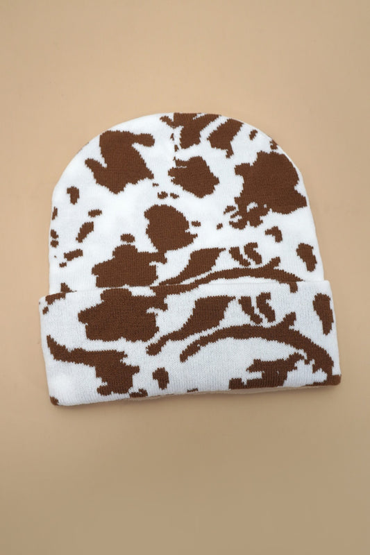 White beanie with brown abstract pattern on a beige background