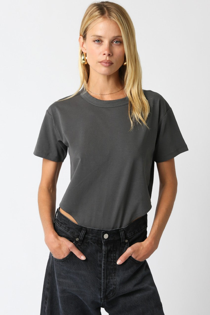 Model wearing the Danika Bodysuit in charcoal gray with relaxed round neck and casual fit