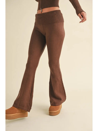 Brown ribbed knit pants worn by a person on a beige background