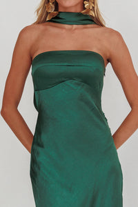 Green strapless dress worn by a person on a plain background