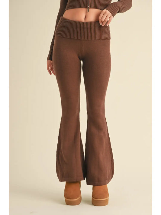 Brown ribbed knit top and flared pants on a beige background