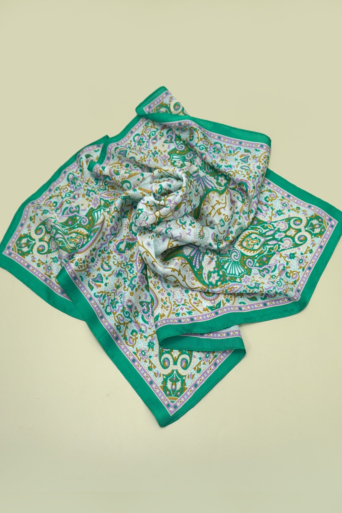 Green patterned scarf on a beige background