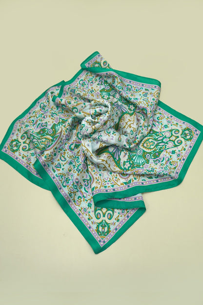 Green patterned scarf on a beige background