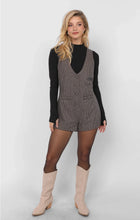Load image into Gallery viewer, Model wearing wool-blend plaid romper with button front and tailored vest-style top layered over black mock neck