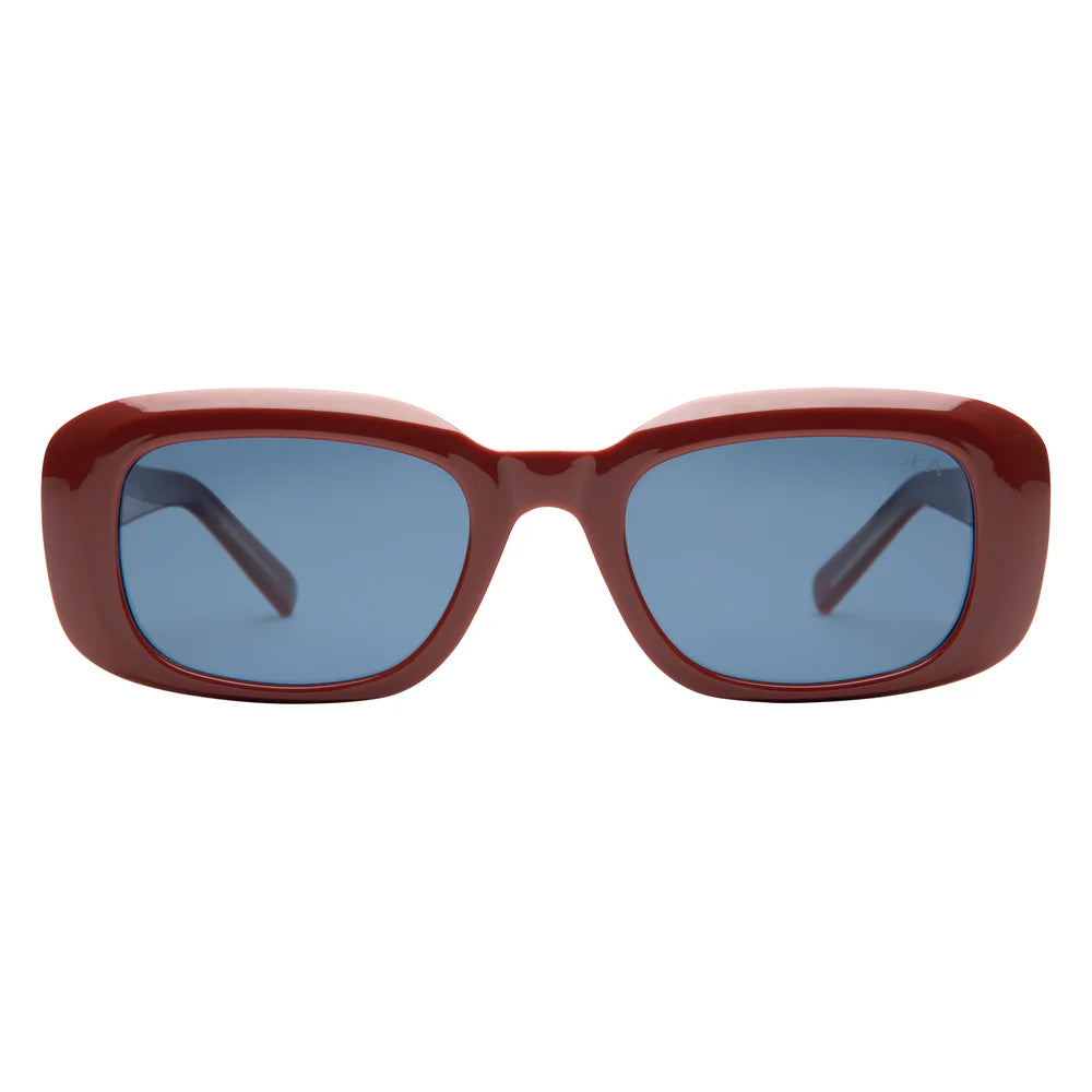 Sunglasses with a red frame and blue lenses on a white background
