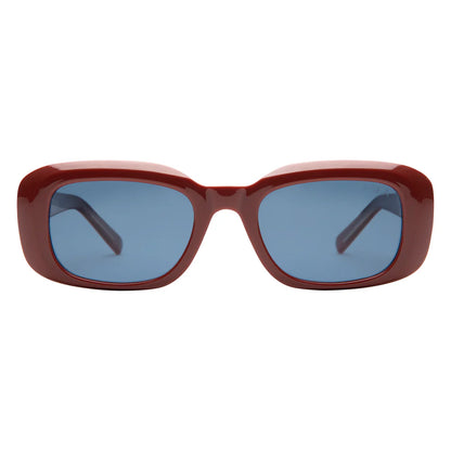 Sunglasses with a red frame and blue lenses on a white background