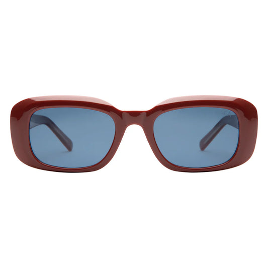 Sunglasses with a red frame and blue lenses on a white background