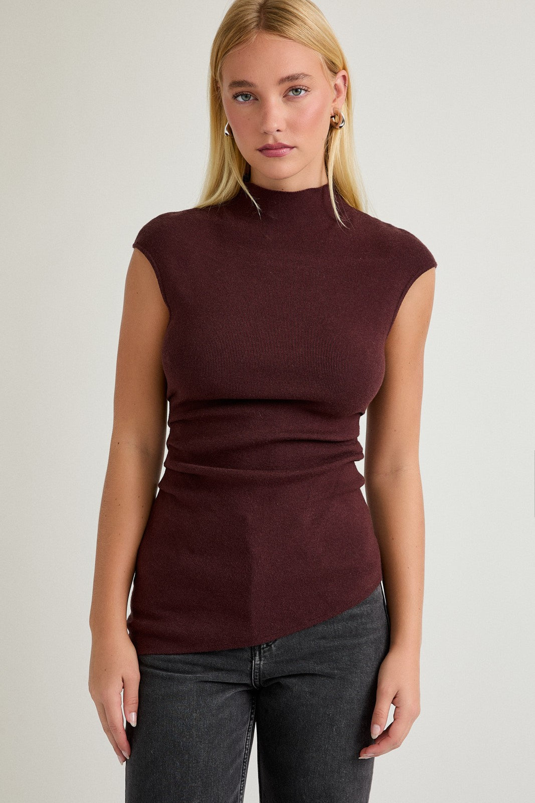 Model wearing wine-colored Night of My Life Top with mock neck and shirred waist
