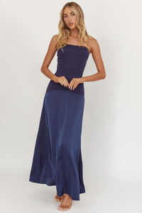 Model wearing Midnight Grace Strapless Dress in navy with fitted bodice and flowing maxi skirt