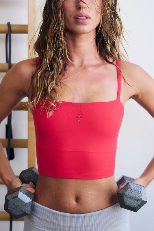 woman wearing red fitted bandeau active crop top holding dumbbells